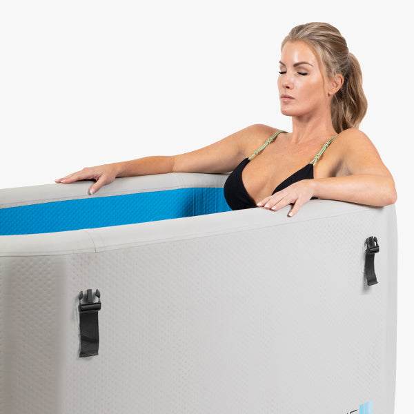 Woman relaxing in inflatable plunge pool, part of 6 person traditional sauna set