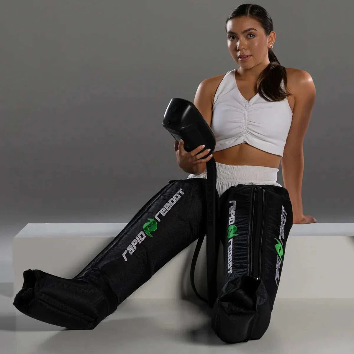 woman wearing Rapid Reboot Boot Attachments compression recovery boots for leg circulation and muscle recovery