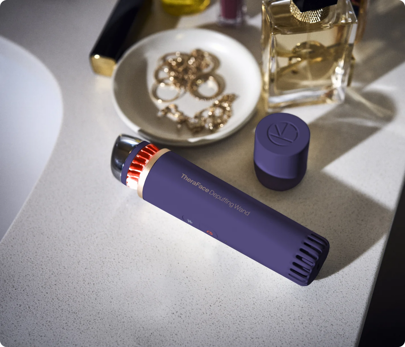 TheraFace Depuffing Wand for hot and cold under-eye treatments on vanity table