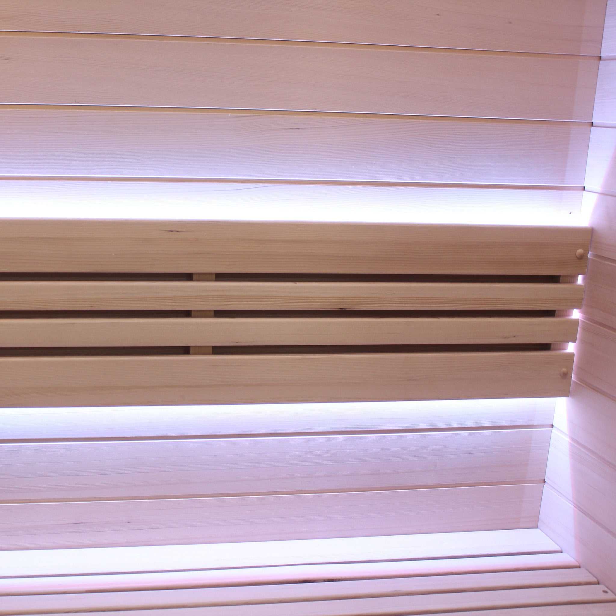 2 person traditional sauna interior with two-tiered wooden bench and LED lighting