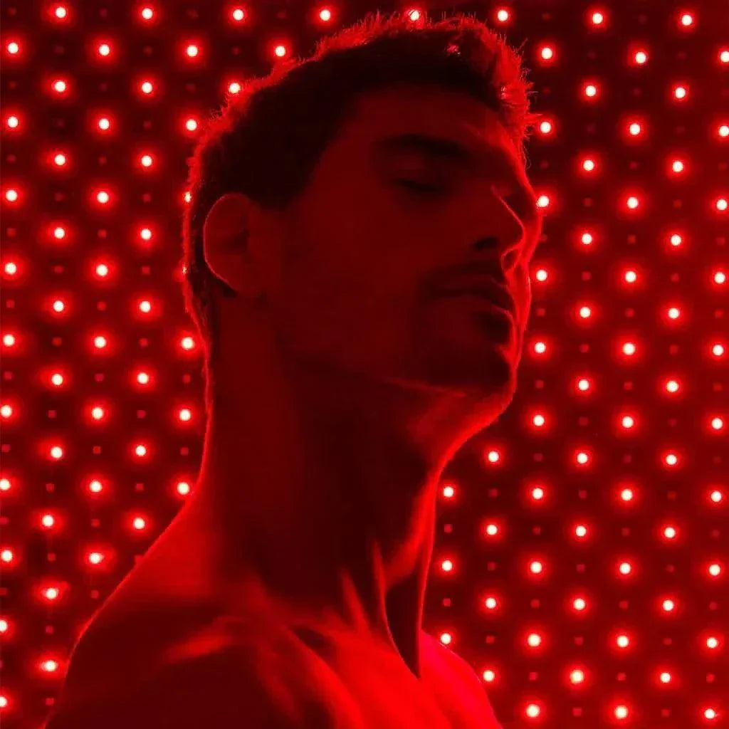 Man using Nushape Red Light Therapy Mat with 660nm and 850nm LEDs for full-body healing and recovery