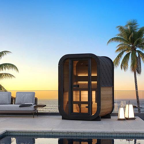 SaunaLife Model CL3G outdoor home sauna kit on poolside patio with palm trees at sunset