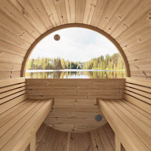 Interior view of SaunaLife Model E7W sauna barrel with panoramic half-moon window overlooking lake and forest
