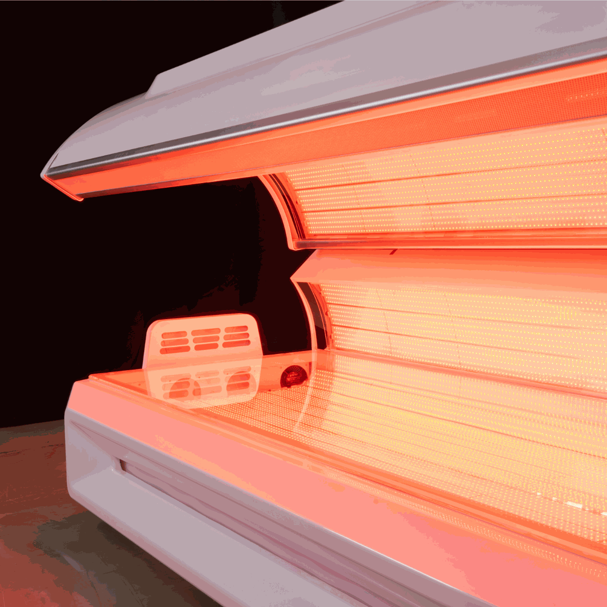 Modern red light therapy bed with 360 degree LEDs and built-in cooling fans for home and commercial use