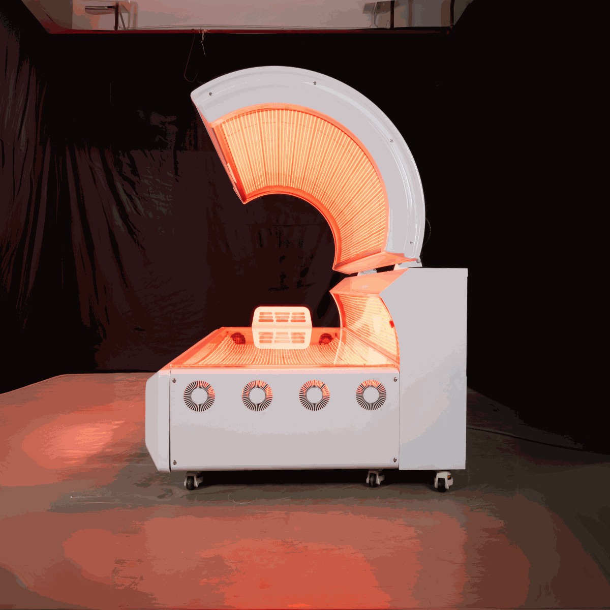 Commercial-grade red light therapy bed with 360-degree LED lights and cooling fans for home and business use