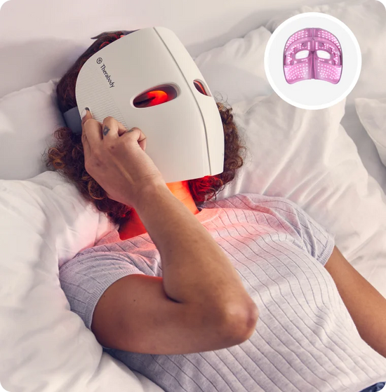 Person using TheraFace Mask full-face LED light therapy device for skin rejuvenation at home