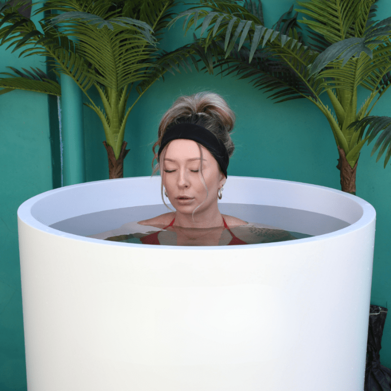 Woman relaxing in Cold Life Ultimate Plunge vertical cold plunge tub for recovery and wellness.
