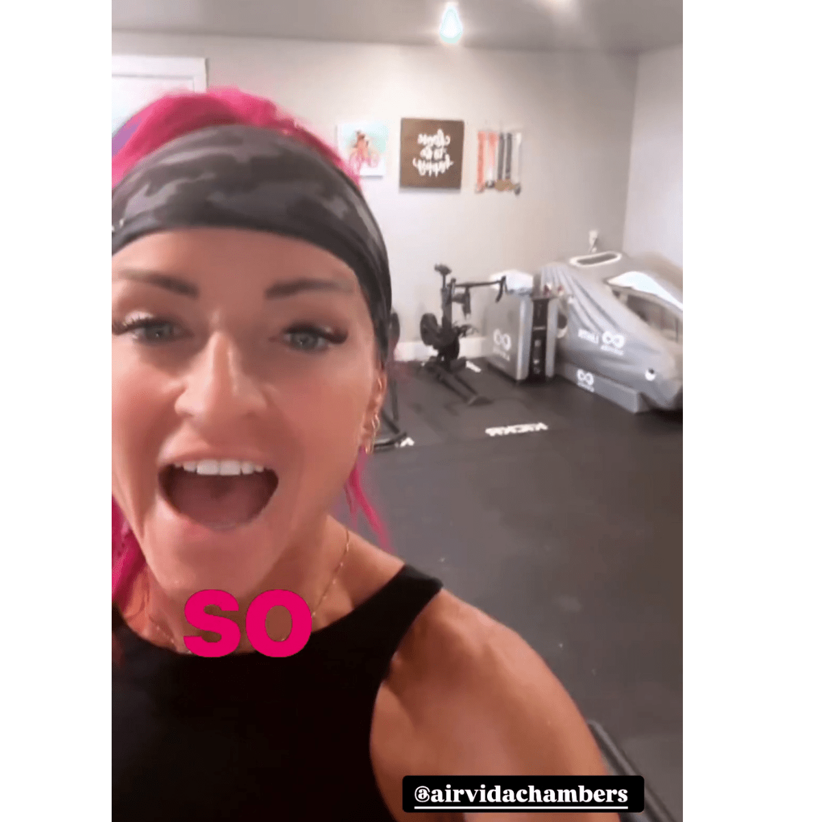 Woman in gym with Airvida Pro90 portable seated hyperbaric wellness chamber in background