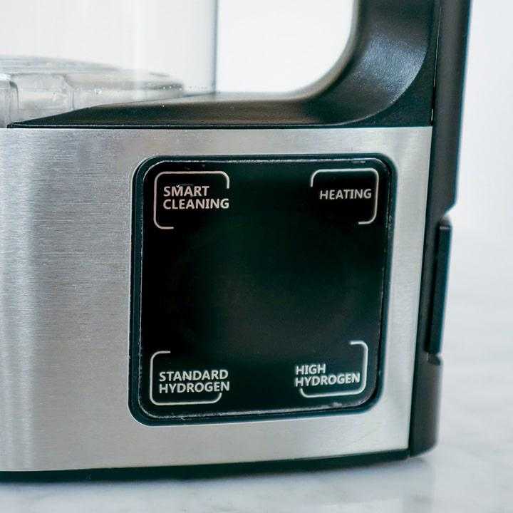 Close-up of control panel on hydrogen water pitcher showing smart cleaning, heating, standard hydrogen, and high hydrogen settings