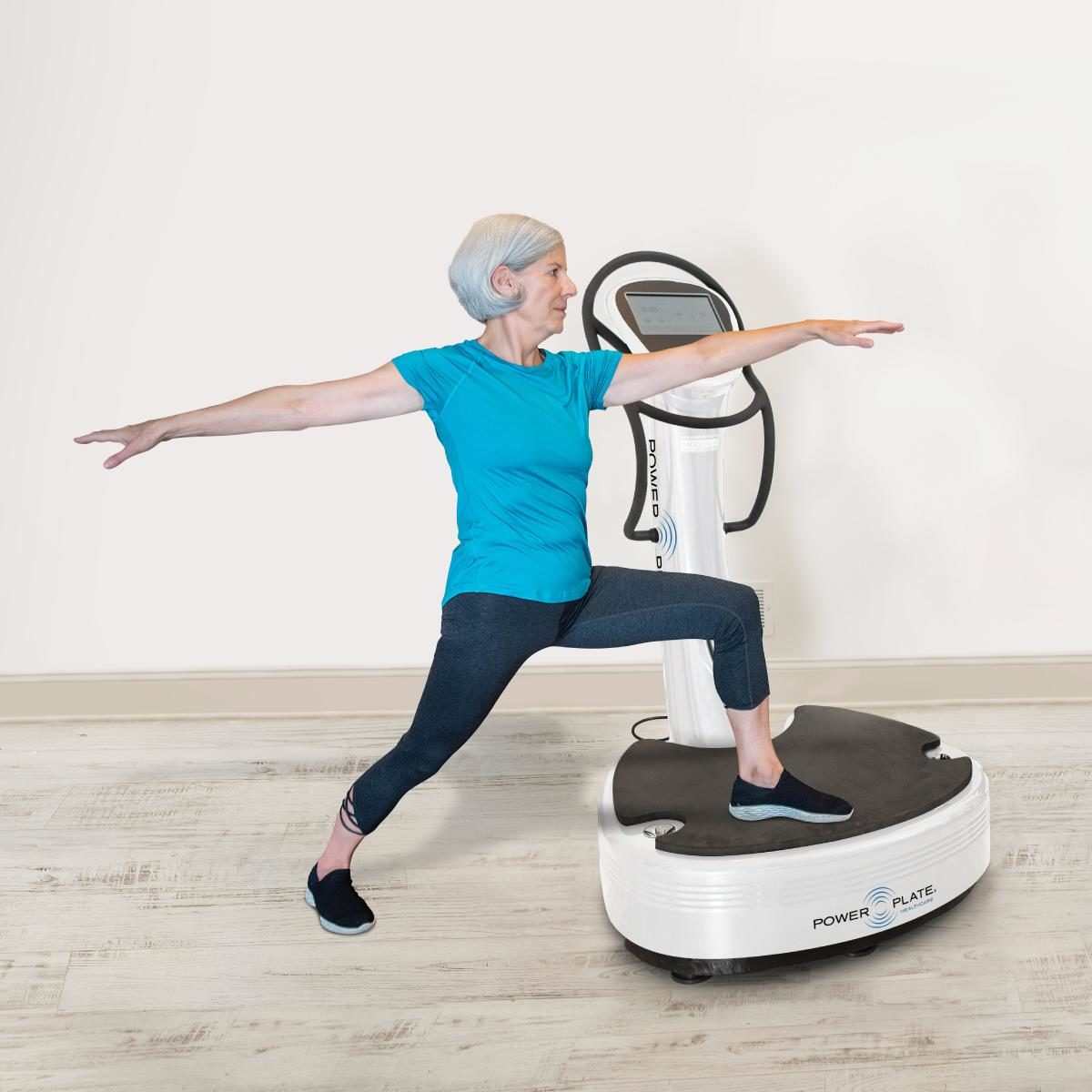 Elderly woman exercising on Pro7HC vibration plate healthcare equipment for muscle recovery and neurological health