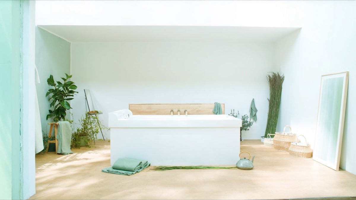 White cold plunge tub in a bright airy room, an at-home recovery setup for Independence Day weekend