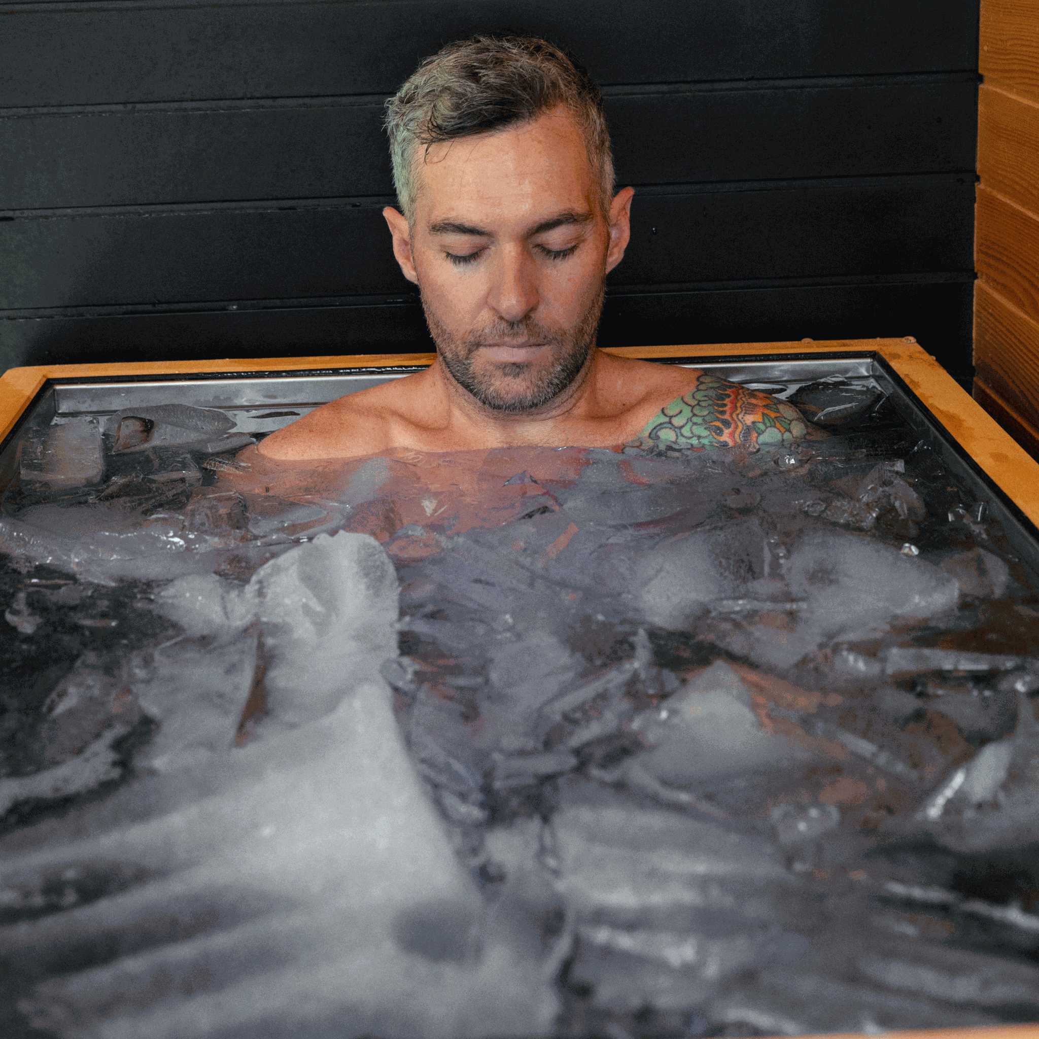 Man using Luxury Plunge ice bath with sleek insulated stainless steel tub and ice-cold therapy