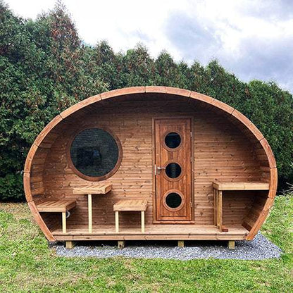 SaunaLife GL6 outdoor wooden barrel sauna kit with round window and wooden door on grassy lawn
