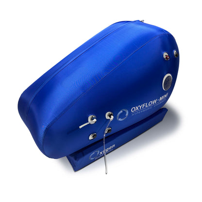 Front-zip soft-shell hyperbaric chamber with transparent viewport windows, side angle