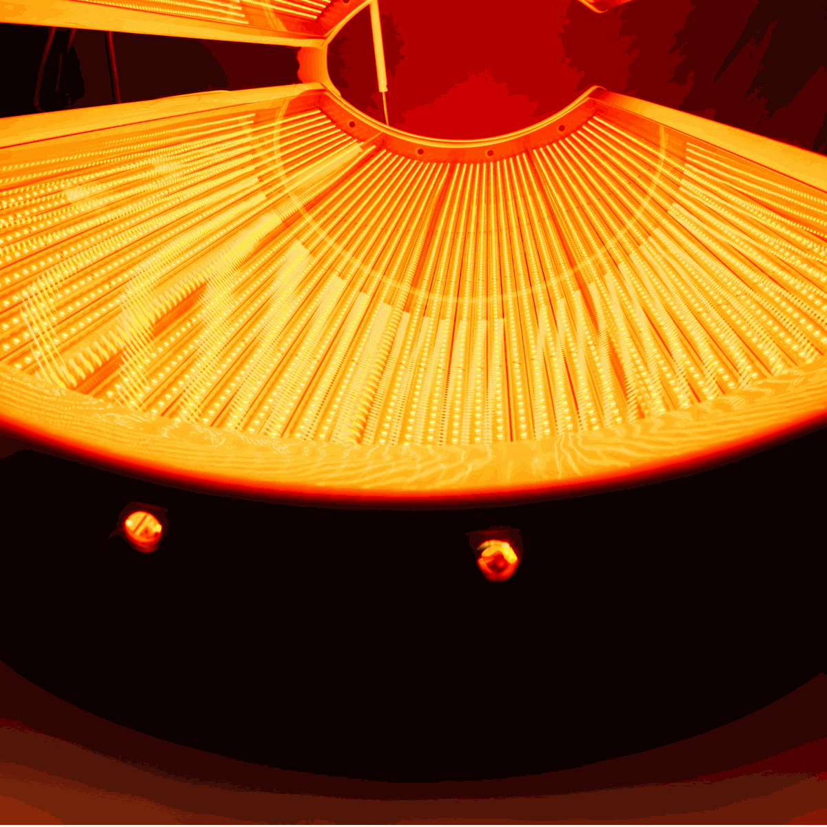 Close-up inside view of Airvida Aura Red Light Recovery system Bed with high-quality LED array glowing bright red light recovery system bed