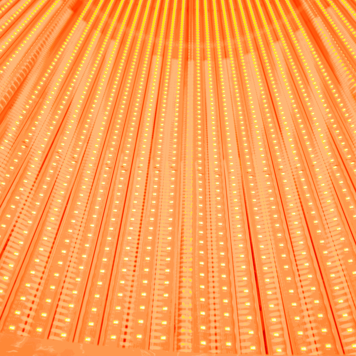 Close-up of illuminated red LED array on a red light recovery system bed panel for home and commercial use