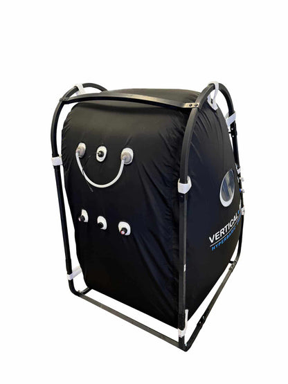 Upright single-person hyperbaric oxygen chamber with viewport windows and zippered door