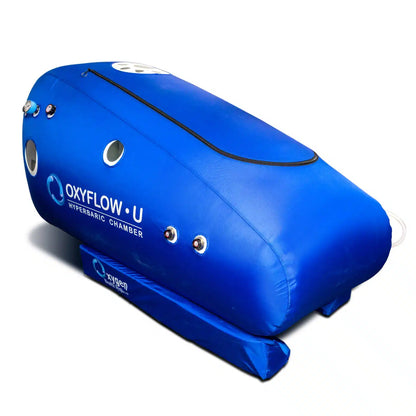Sitting soft-shell hyperbaric oxygen chamber with wide U-shaped door, front diagonal view