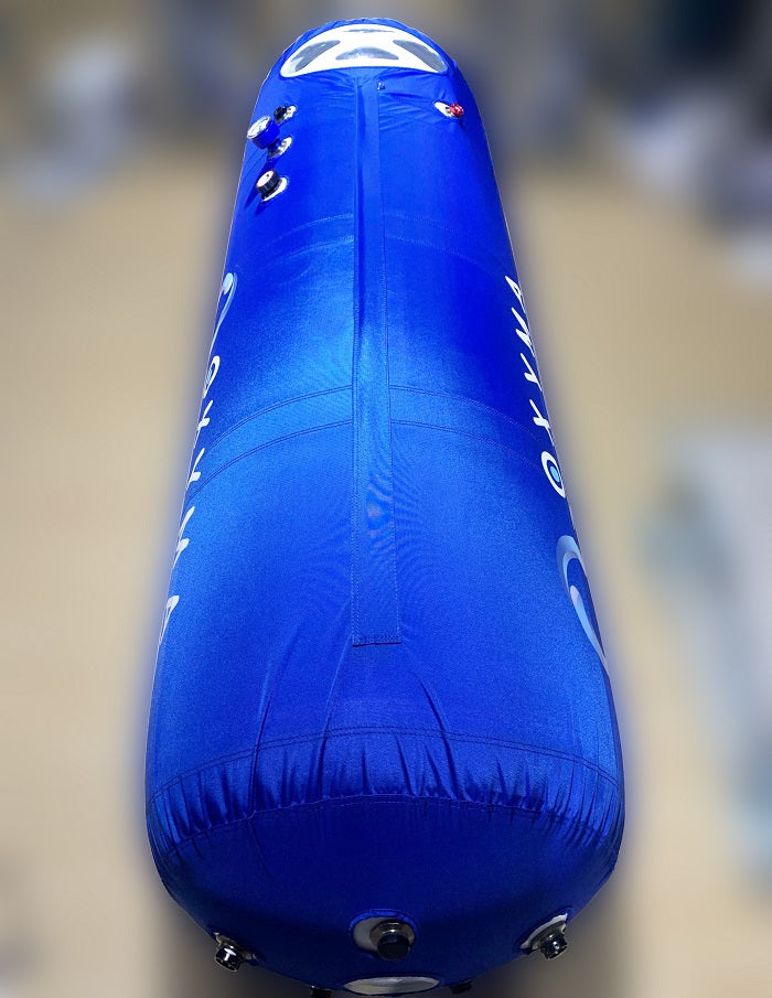 Interior of the Oxyma 28-inch hyperbaric chamber showing mattress, viewports, and comfortable lie-down space
